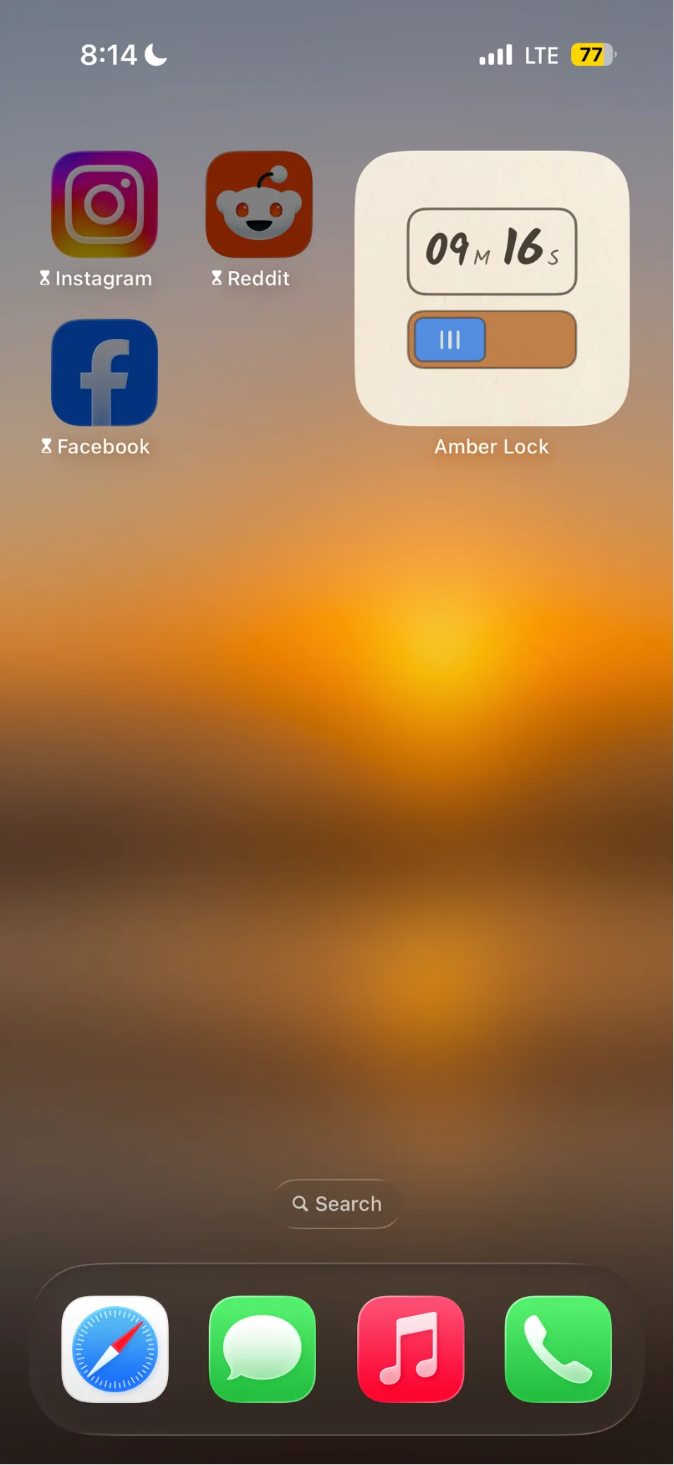 The Amber Lock widget on an iPhone home screen, showing 9 minutes 16 seconds banked, beside sealed Instagram, Reddit and Facebook icons.